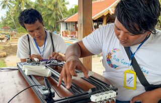 Wira and Wilan playing the Mangsynth at Dinacon Bali 2025